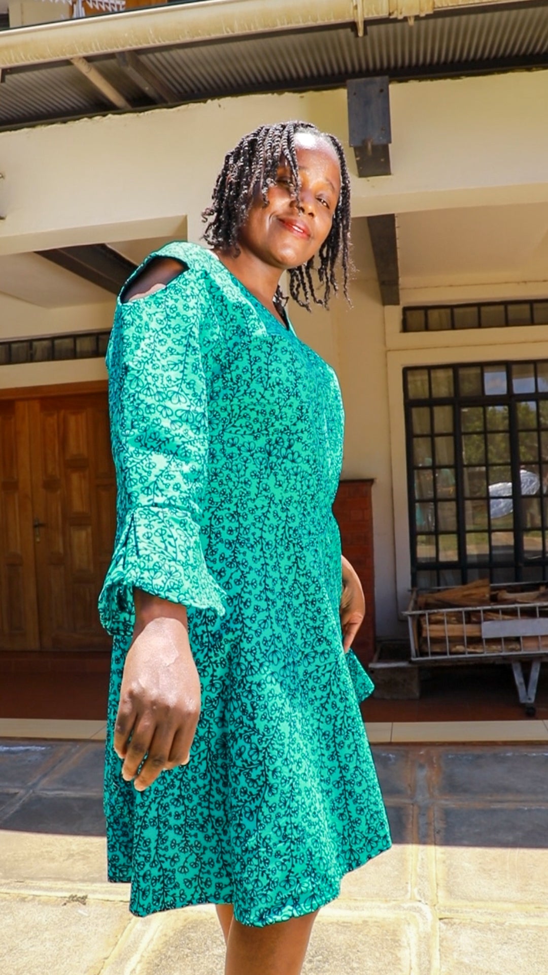 A-Line - turqouise green and black floral motif. Long flared sleeves.