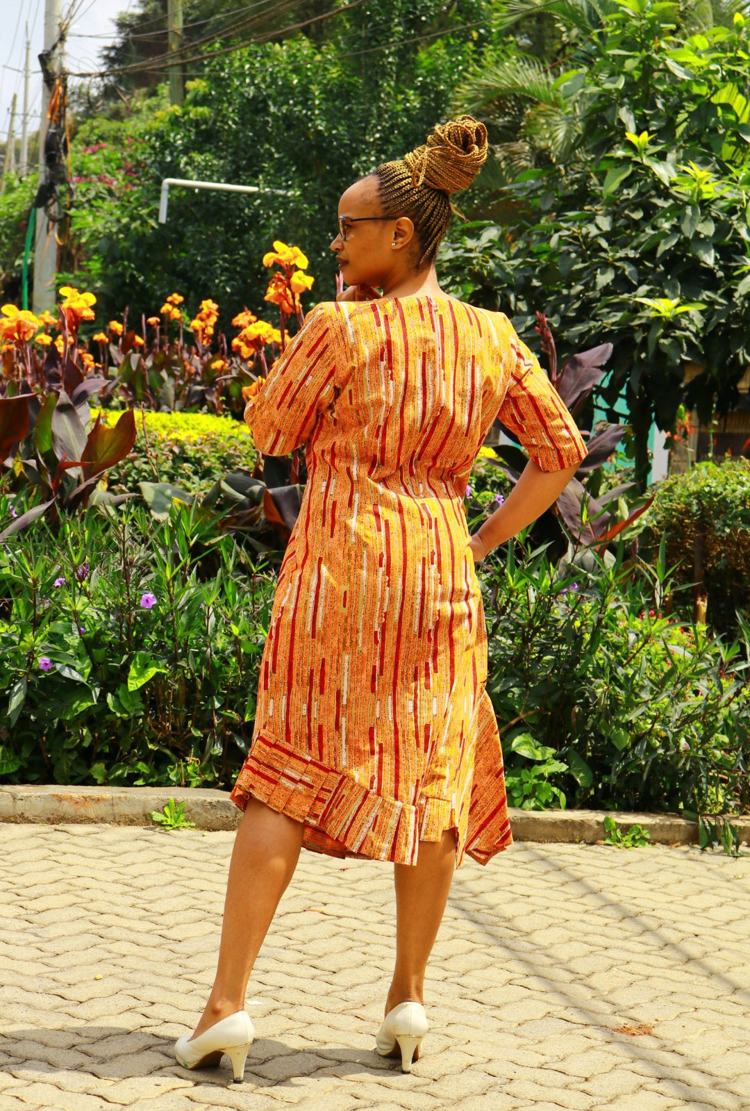 Dress of Orange, cream, red lines and dots motif.