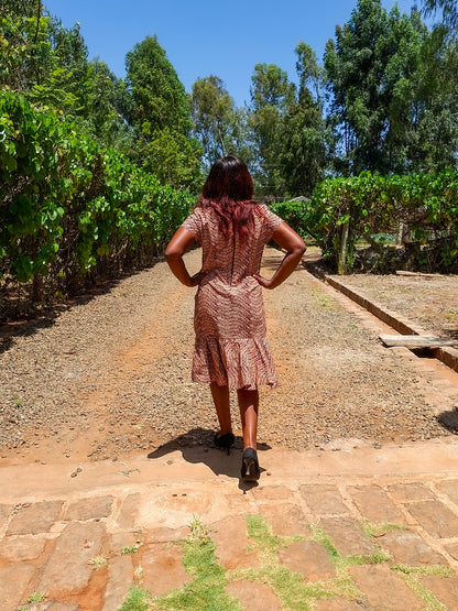 Sheath dress of peach and brown leaf motif