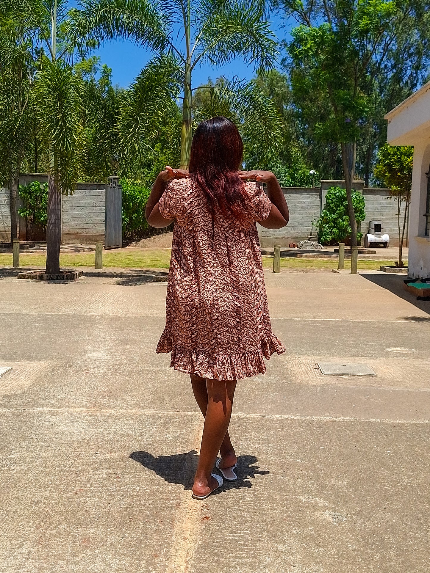 Sheath dress of peach and brown leaf motif