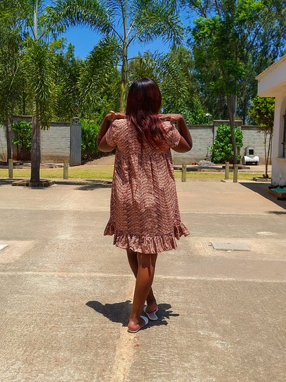 Sheath dress of peach and brown leaf motif