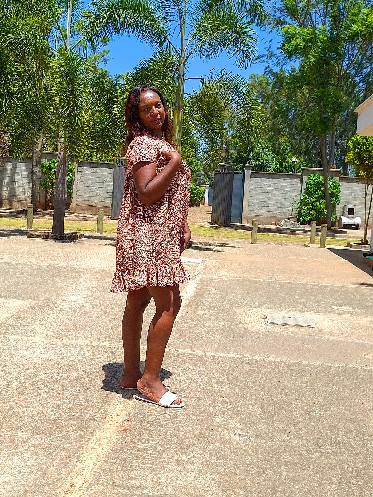 Sheath dress of peach and brown leaf motif