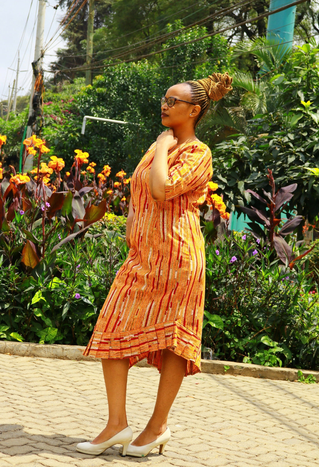 Dress of Orange, cream, red lines and dots motif.