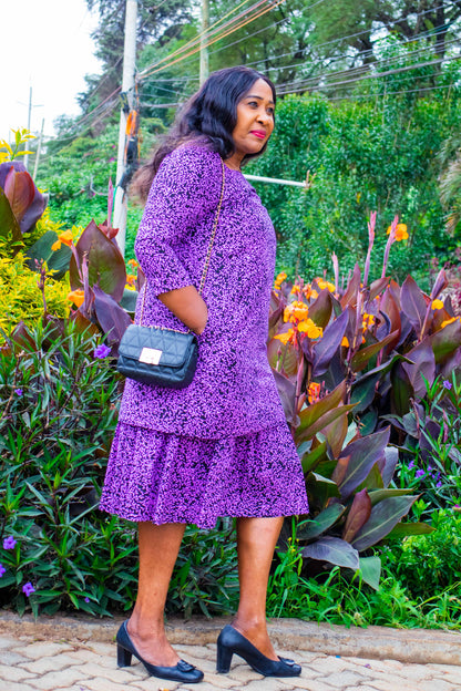 A-Line dress with bottom ruffles. Black ground  and lilac floral motif