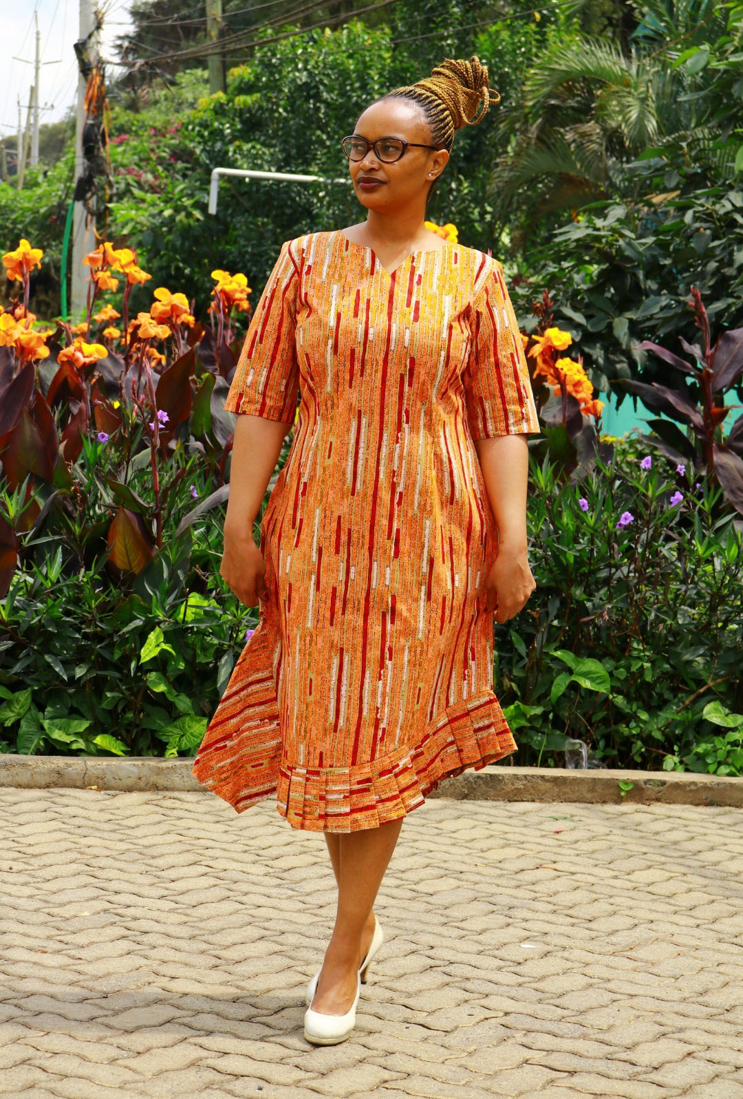 Dress of Orange, cream, red lines and dots motif.