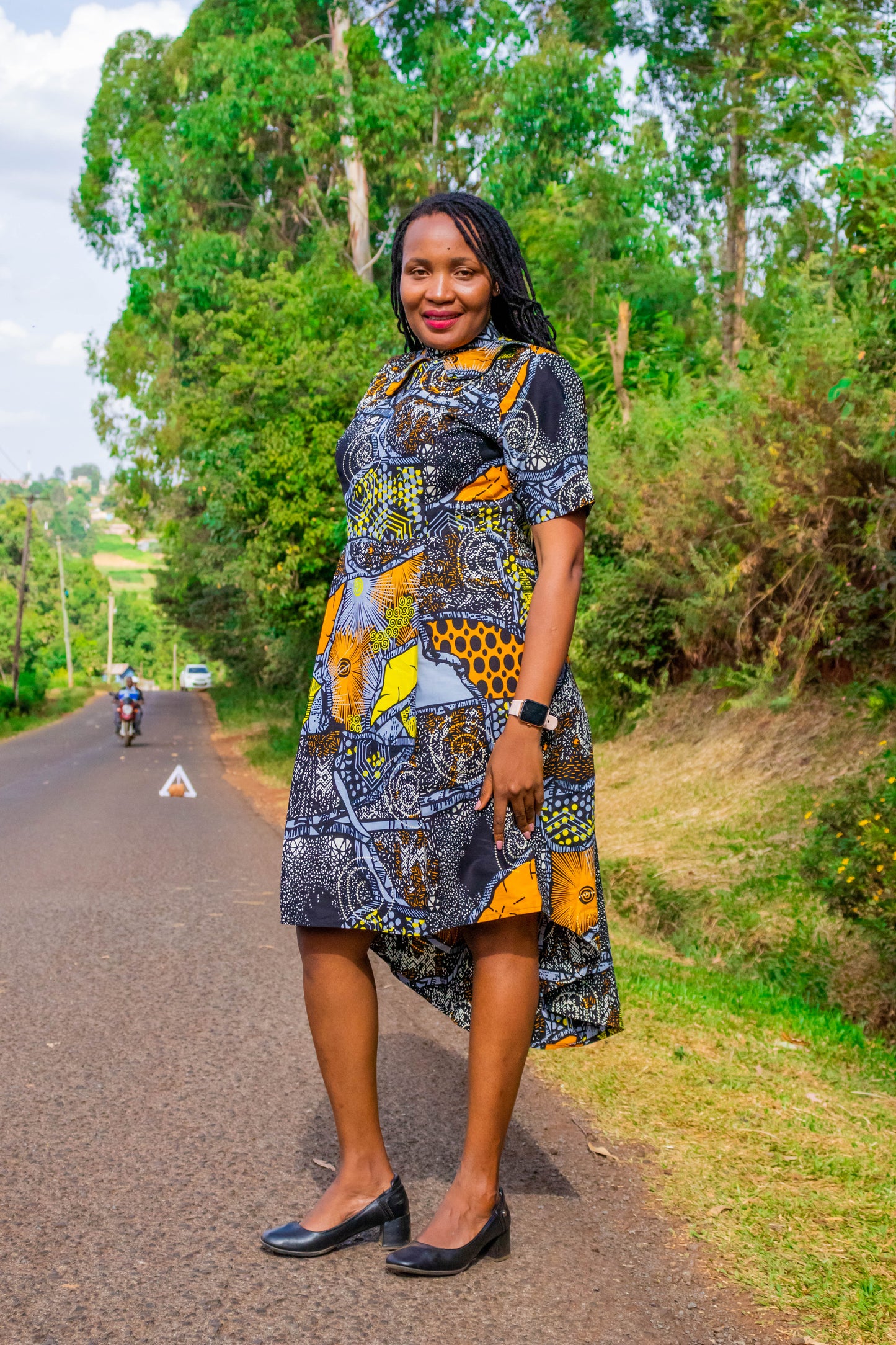 Mullet dress of black, grey, orange, white and yellow motif