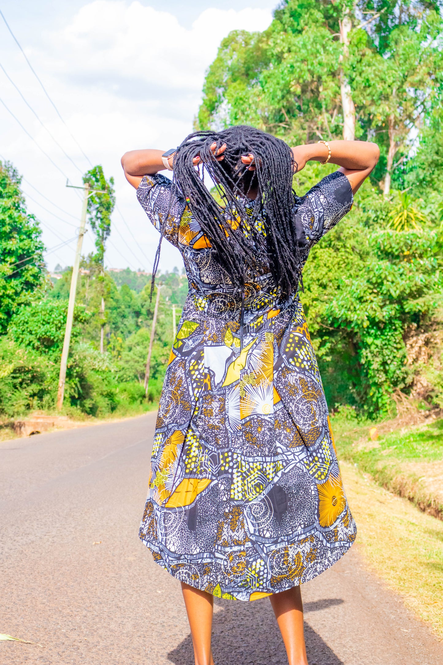 Mullet dress of black, grey, orange, white and yellow motif