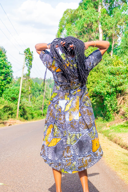 Mullet dress of black, grey, orange, white and yellow motif