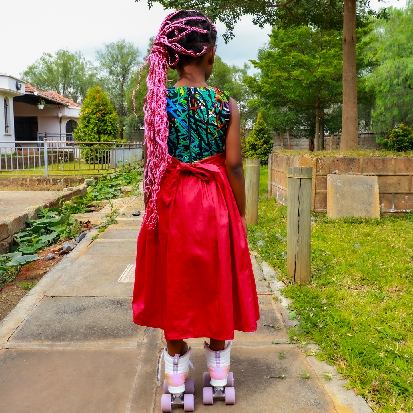 Dress: Bodice of green, tourqoise, red and black motif,Skirt of red satin material