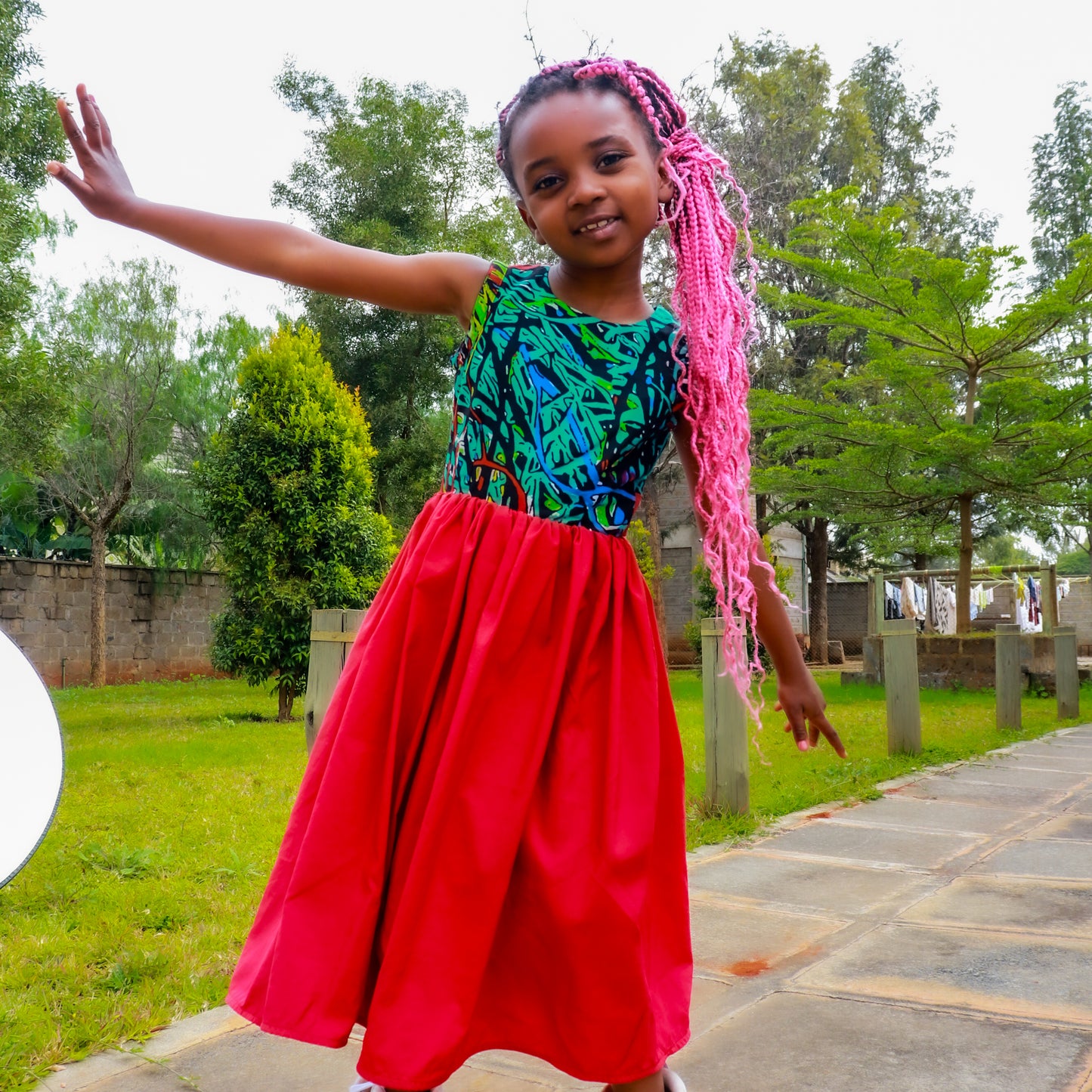 Dress: Bodice of green, tourqoise, red and black motif,Skirt of red satin material